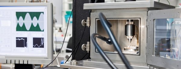 Corrosion Laboratory equipment with a computer screen displaying waveforms.