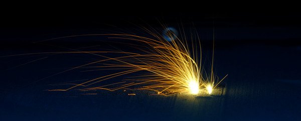 Sparks flying in a dark setting.