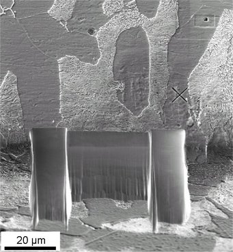 Fig. 2: Microstructure of the investigated pearlitic steel sample after milling. The cross on the right side of the milled area is the alignment marker. The two deeper milled areas left and right have been milled with a coarse beam to avoid shadowing of the EBSD camera. Fig. 2: Microstructure of the investigated pearlitic steel sample after milling. The cross on the right side of the milled area is the alignment marker. The two deeper milled areas left and right have been milled with a coarse beam to avoid shadowing of the EBSD camera.