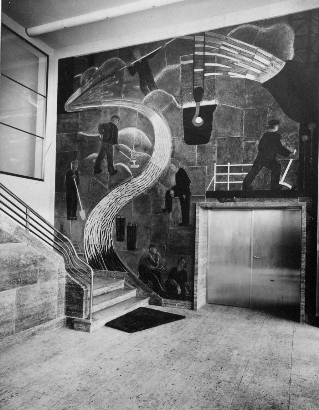 Mural depicting industrial scenes next to an elevator in a building lobby.