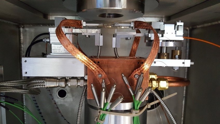 The straining rig with hot stages housed in an environmental chamber The straining rig with hot stages housed in an environmental chamber
