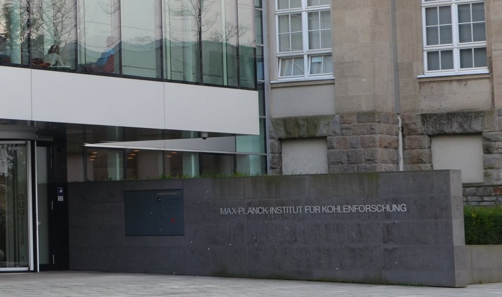 Modern building with large glass windows and an entrance.