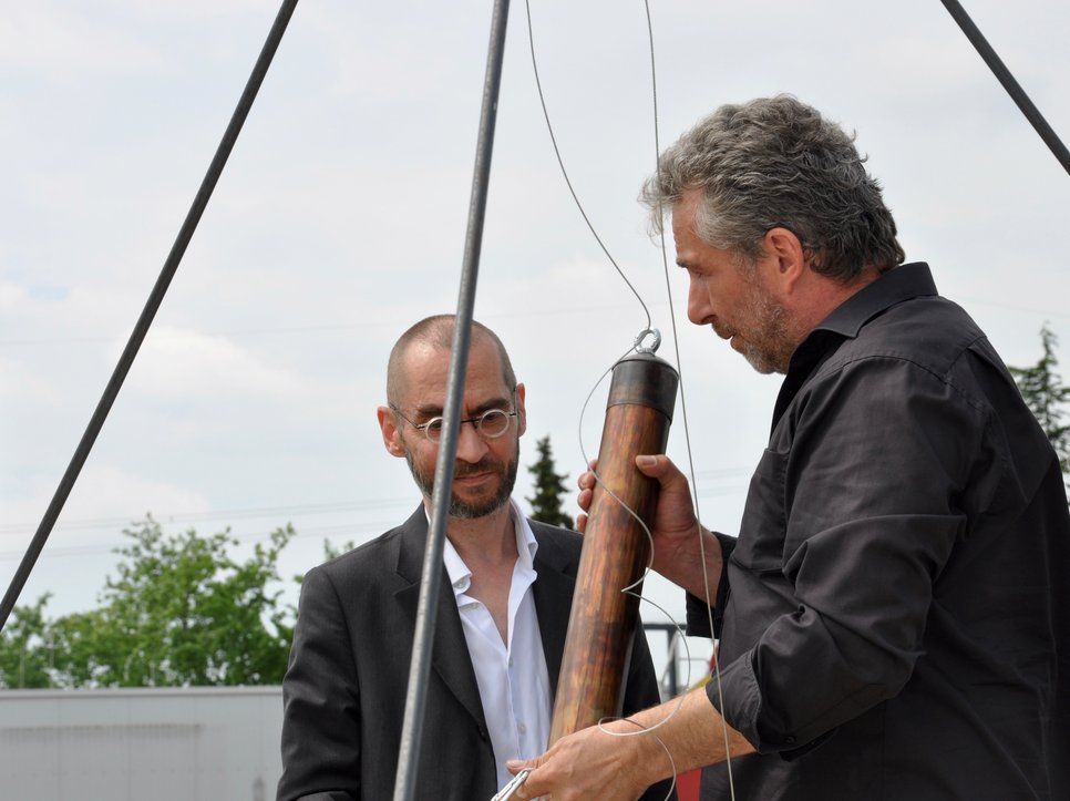 Michael Schrader (right) inserts the time capsule.