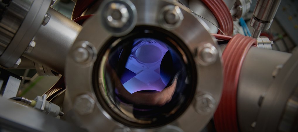 Metallic apparatus with a glowing purple interior.