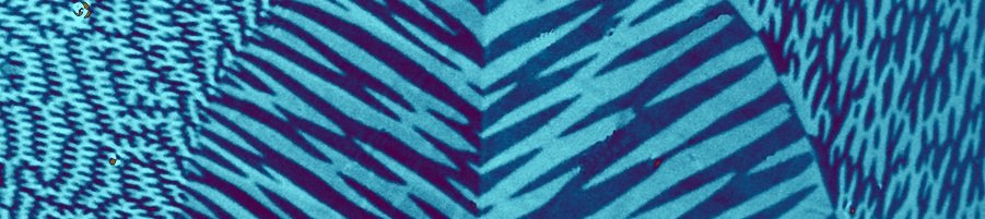Close-up of an abstract design with blue and purple diagonal lines creating a geometric pattern.