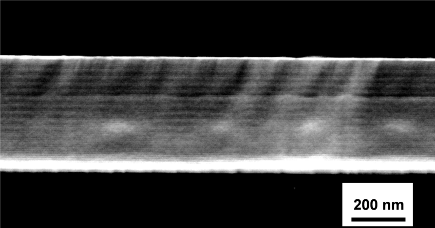 SEM cross-section image of a fully amorphous metallic glass multilayer, alternating layers with two different compositions: Zr24Cu76 and Zr61Cu39 SEM cross-section image of a fully amorphous metallic glass multilayer, alternating layers with two different compositions: Zr24Cu76 and Zr61Cu39