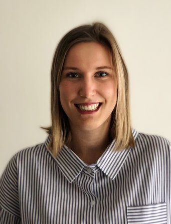 Shoulder-length hair, striped shirt with pocket, buttoned collar.