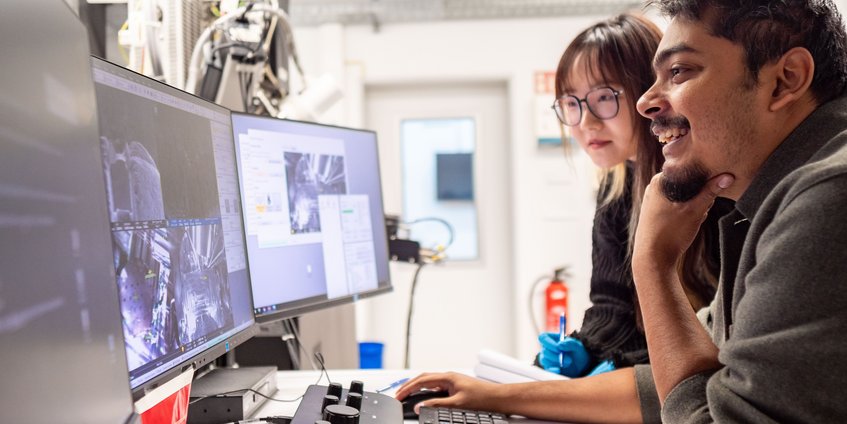 Microstructure and Properties Two persons looking at screens showing images from a microscope
