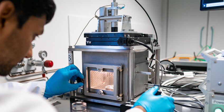 Advanced Materials Person looking into a scientific device