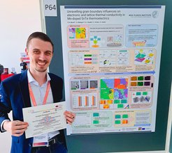 Person standing next to scientific poster about thermoelectrics.