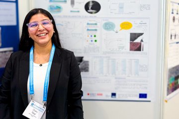 Person standing in front of scientific poster about corrosion protection