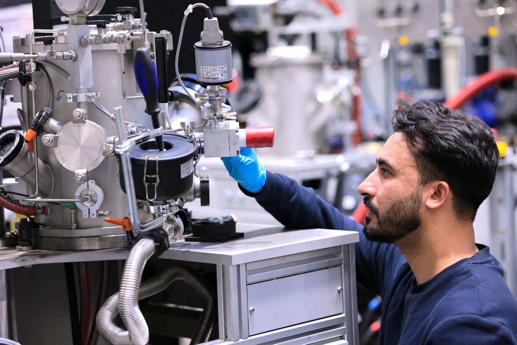 Ubaid Manzoor adjusting the hydrogen partial pressure in the electric arc furnace to extract copper, nickel and cobalt from deep-sea polymetallic nodules. A scientist operates complex laboratory equipment with numerous hoses, valves and metal casings.