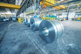 Steel rolls in an industrial area.