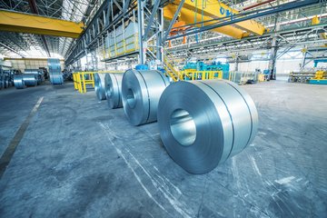 Steel rolls in an industrial area.