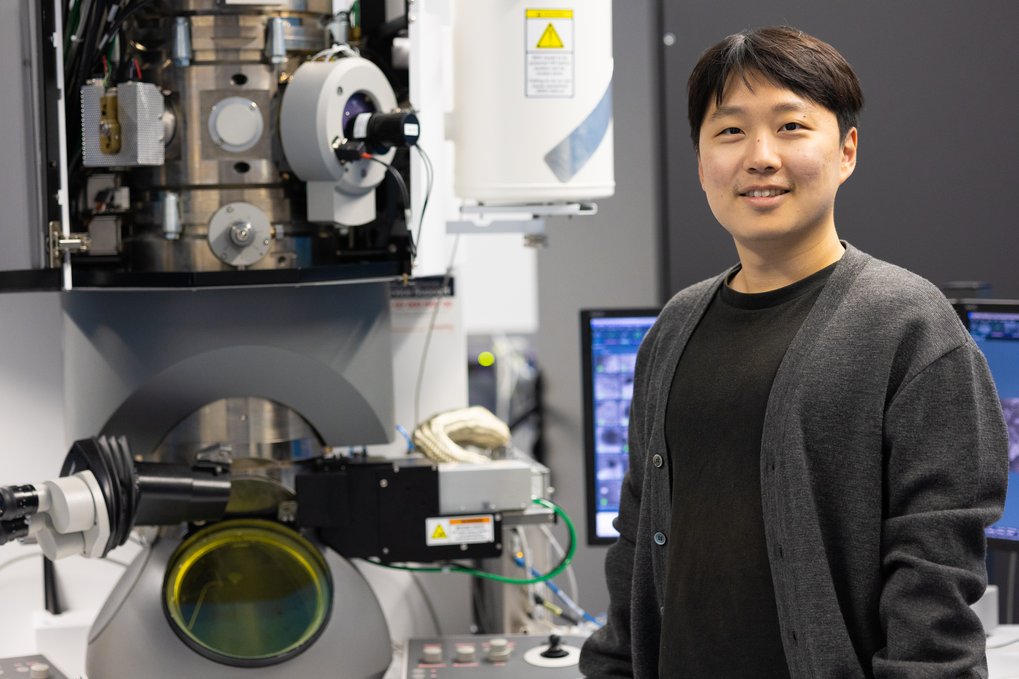 Man standing next to scientific device.